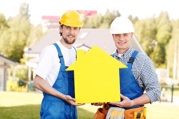 Workers with house model symbol