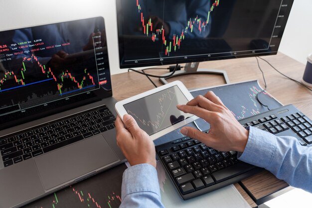 Working business man, team of broker or traders talking about forex on multiple computer screens