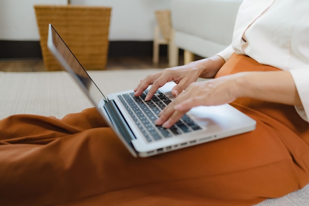 Working by using a laptop computer on wooden table Hands typing on a keyboardtechnology ecommerce concept