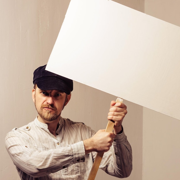 Working in a cap holding banner over his head