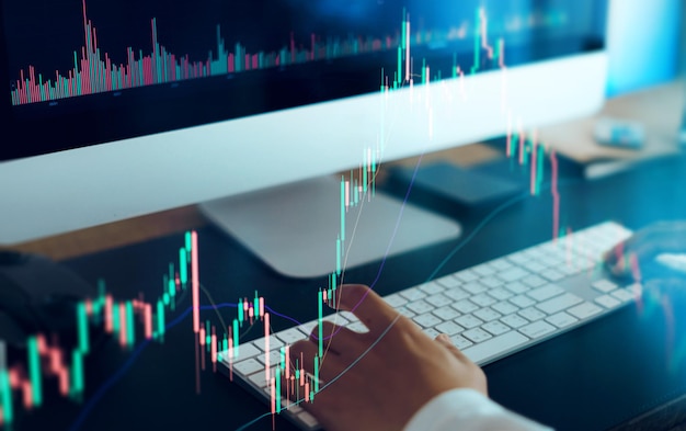 Photo working on a computer and graphing cryptocurrenciesfinance background