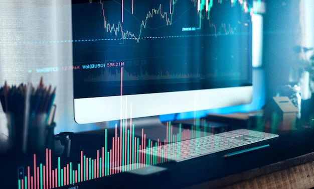 Working on a computer and graphing cryptocurrenciesfinance background