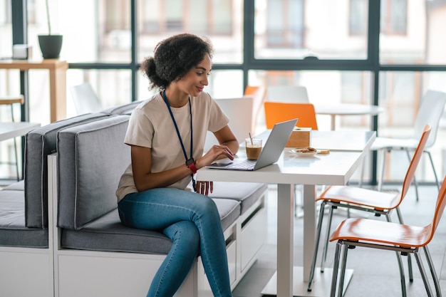 Working day. Young woman sitting at the table and working on laptop