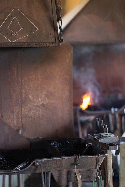 Working forge of the blacksmith in old shop.