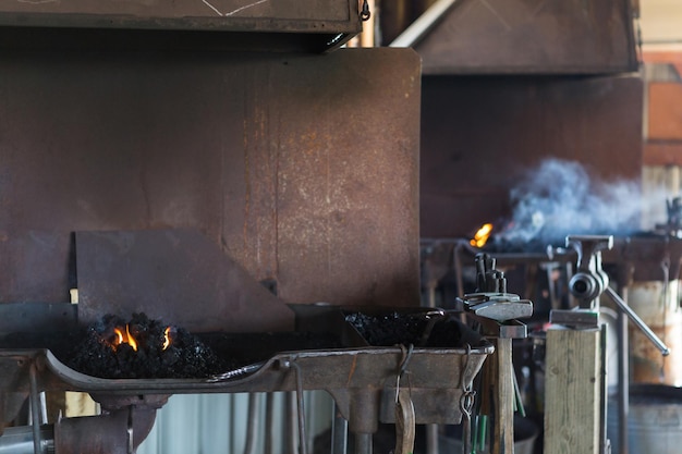 Working forge of the blacksmith in old shop.