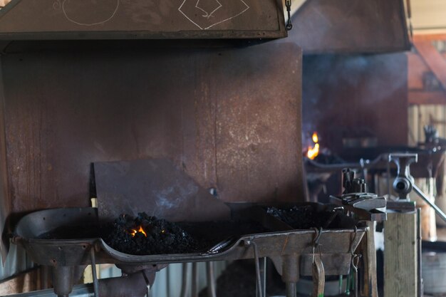 Working forge of the blacksmith in old shop.