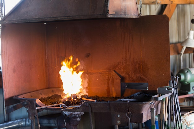 Working forge of the blacksmith in old shop.