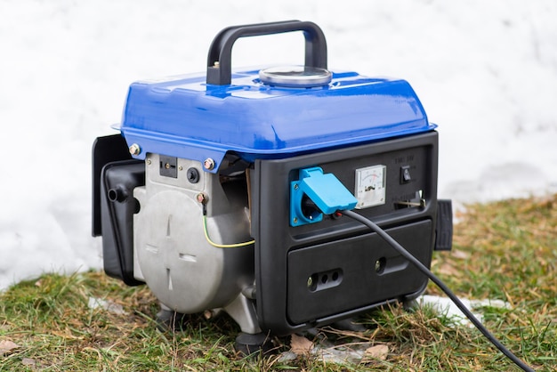 Photo working generator outdoors in winter using gasoline generator during blackouts in ukraine during the war