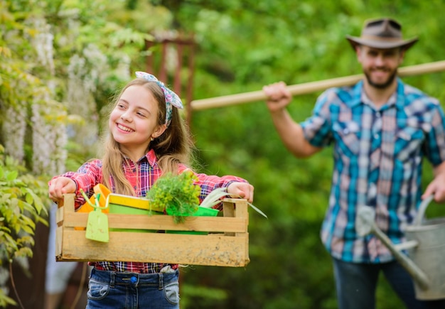 Working in green environment ecology Gardening tools little girl and happy man dad earth day father and daughter on ranch family farm spring village country She loves her job