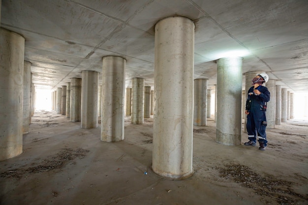 Working male inspection pole underground of tank equipment tunnel By using the flashlight inside under tank.