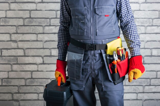 Working man indoors, space for text. Home repair concept. Handyman with toolbox.