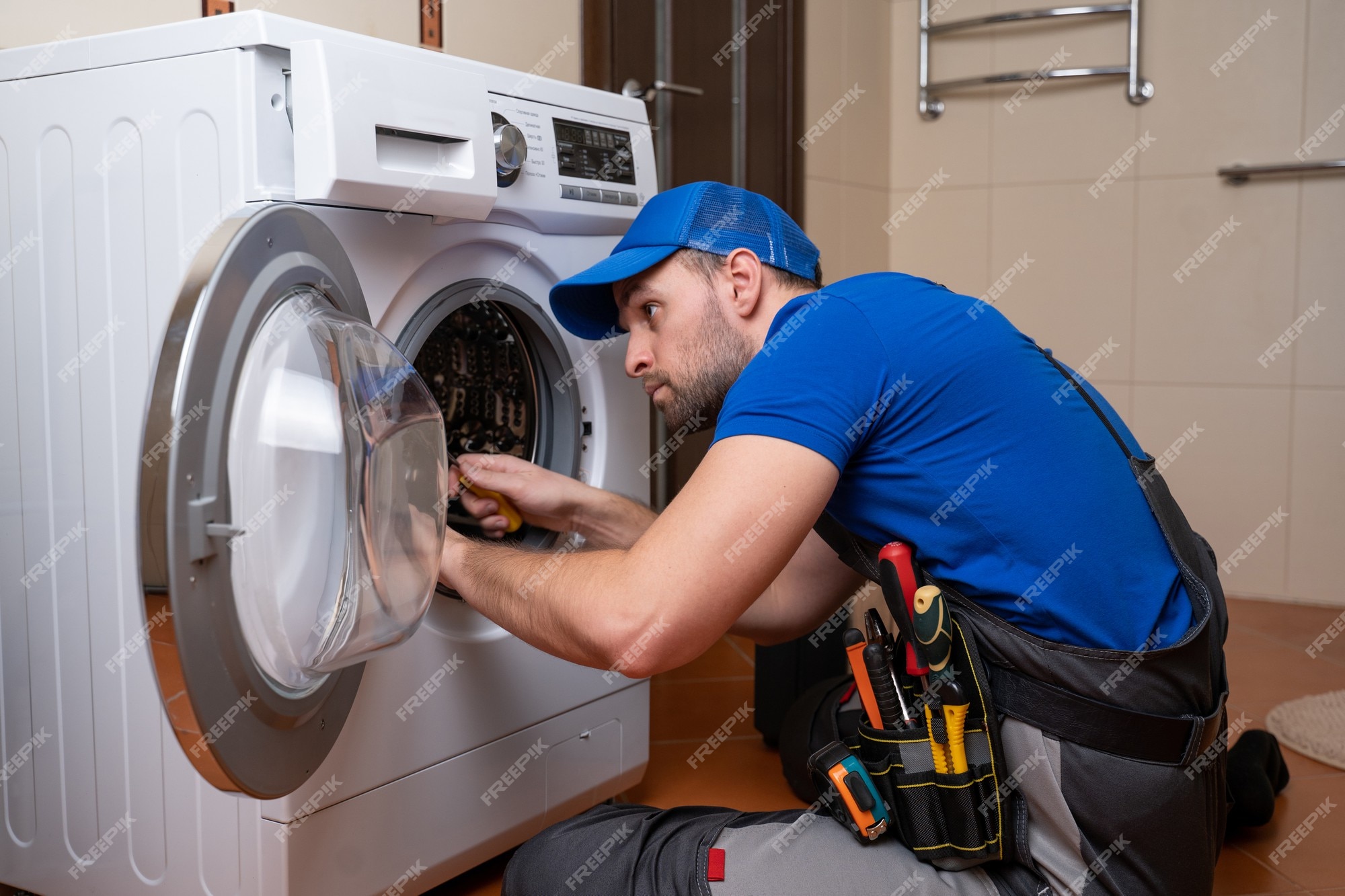 Premium Photo | Working man plumber repairs a washing machine in home washing  machine installation or repair plumber connecting appliance