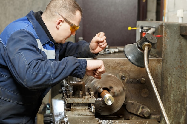 Working mechanic at work at the bench.metal processing.