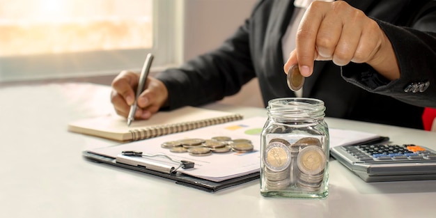 Working men aged 2560 put coins in a glass jar to save money Retirement Financial Planning Ideas Save money and cash Finance Invest Managing business growth