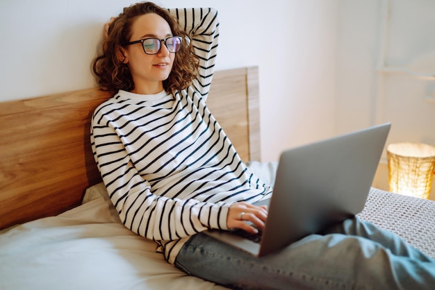 Working online.female freelancer sitting at home and working on laptop online shopping in web store