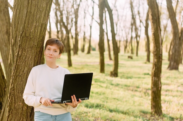 Working online woman laptop park communication technology