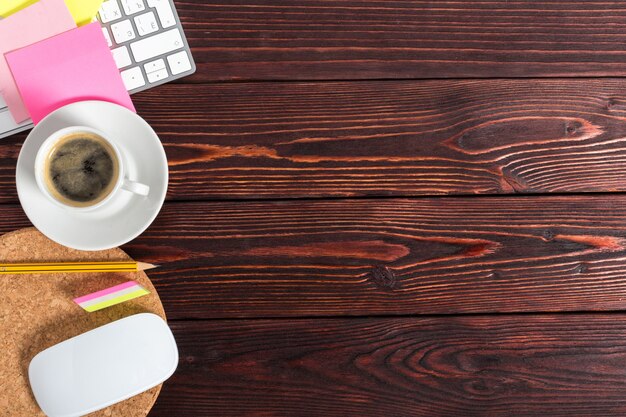 Working place at wooden desktop background with coffee