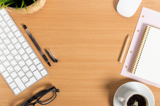 Working place at wooden desktop with coffee