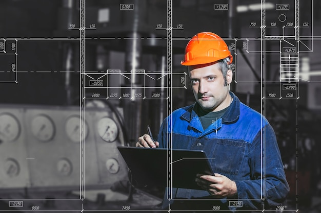 Photo working in production against a background of machines from the engineering drawings