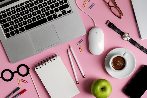 working space business freelance concept top view above flat lay laptop. pink background. 