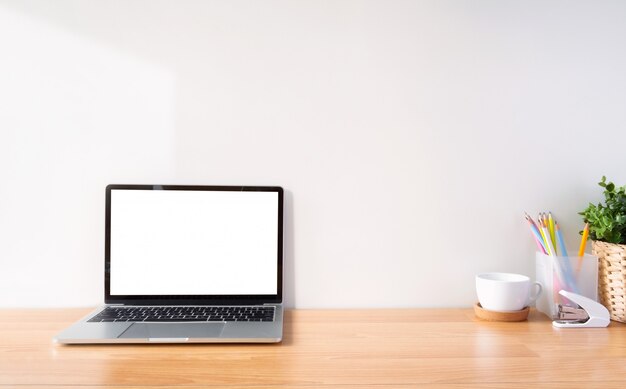  Working space and white screen laptop.