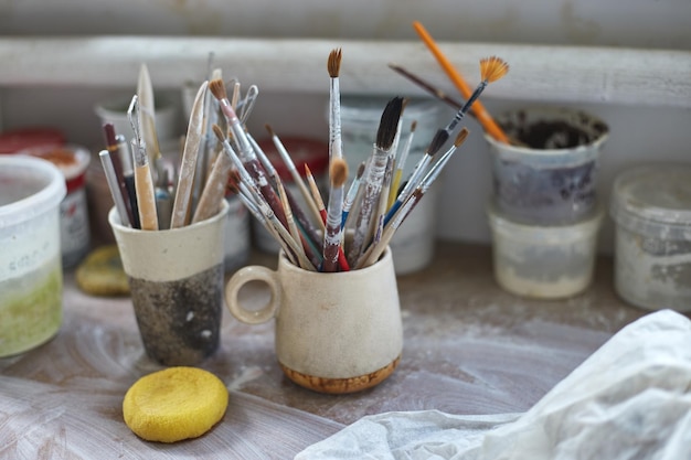 Working table of a ceramist Clay workshop The process of creating pottery The master ceramist works in her studio