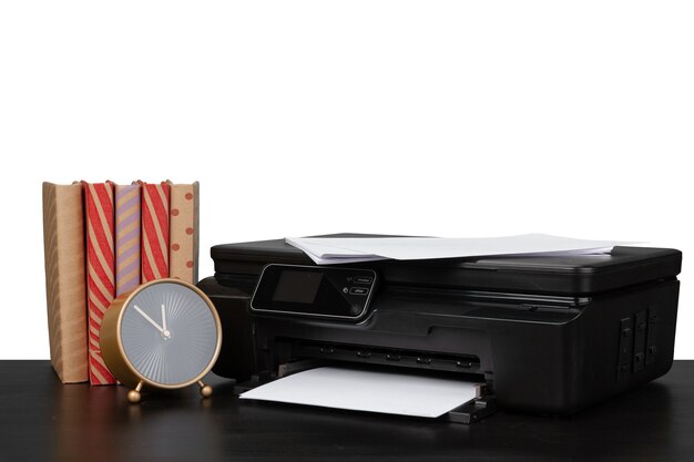 Working table with printer and stacked books on white abckground