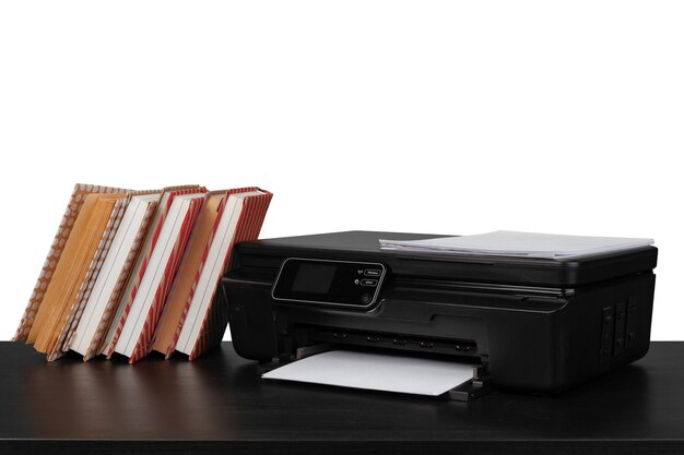 Рабочий стол с принтером и сложенными книгами на белом фоне