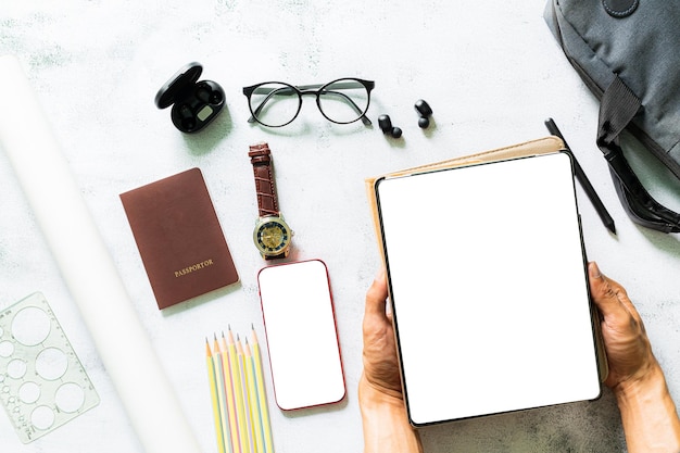 Working on a tablet screen on a white desk,Top view of businesspeople brainstorming on their project