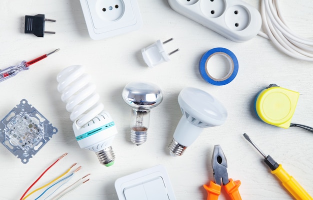 Premium Photo  Working tools, light bulb and components. electrical objects