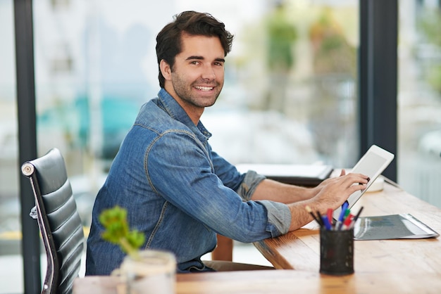 Working to turn his vision into profit Cropped shot of a creative businessman working on his tablet at his desk