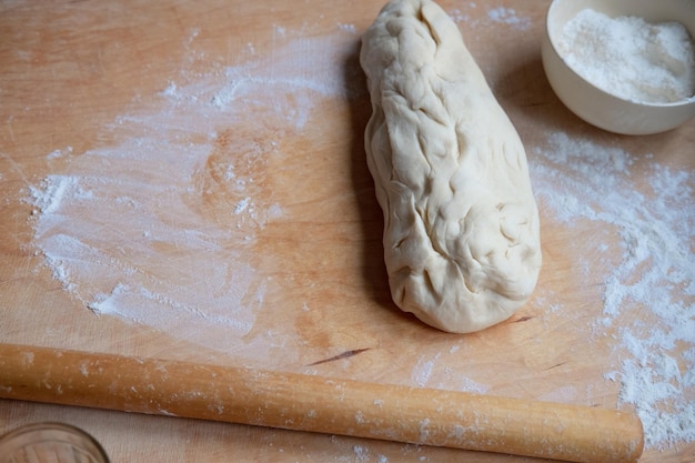 Working on an unfinished rolling pin test Preparing pastries from dough