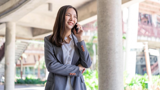 Working woman concept a working woman with smiley face speaking on the phone with her business partner.