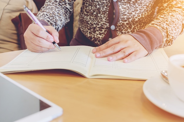 Working woman holding a pen and writing