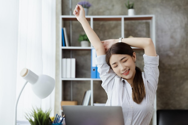 Working woman relaxing a businesswoman in office she is relaxing after working hard for a long time causing fatigue and stress to take a break she has office syndrome Hard work concept