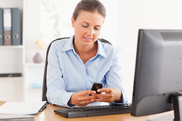 Working woman using her mobile phone