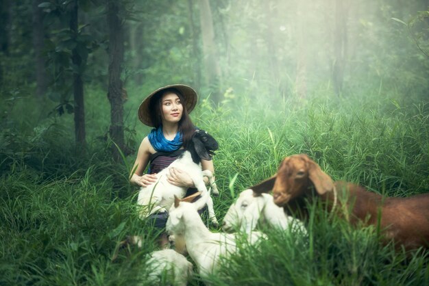 Working women with goat in Thailand