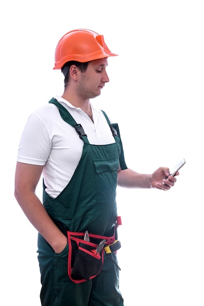 Workman in coverall holding mobile phone isolated on white