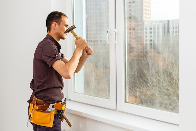 Workman repairing a large picture window