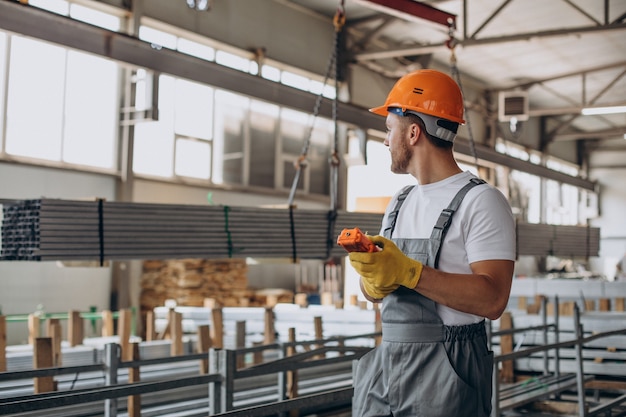 Workman at store house in orange helmet