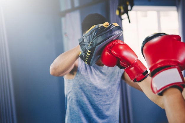 Workout concept; young man practicing workout in class ; young people practicing to boxing and footwork in workout class