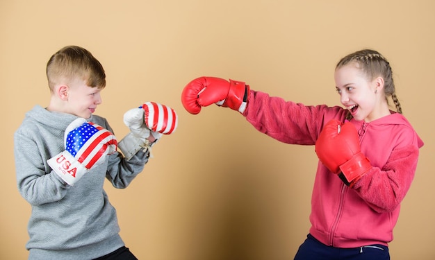 Workout of small girl and boy boxer in sportswear Happy children in boxing gloves Fitness diet punching knockout Childhood activity Sport success Friendship fight Work hard play hard