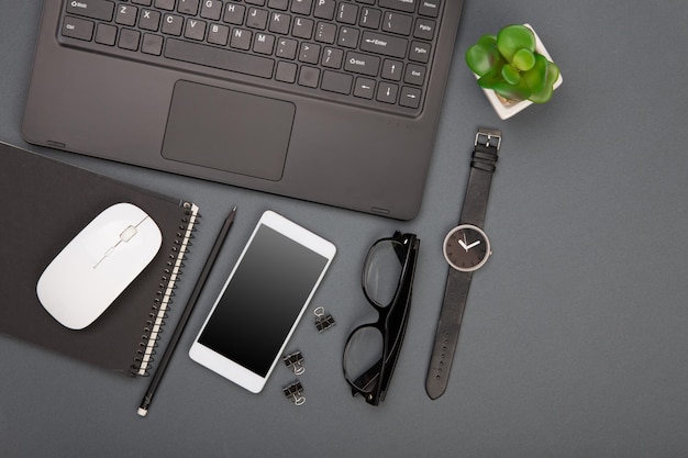 Workplace of businessman laptop smartphone glasses and notepad