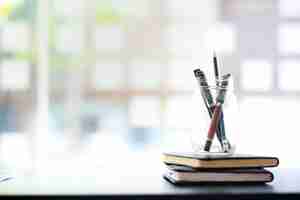 Photo workplace at company office, pen and books on workging desk.