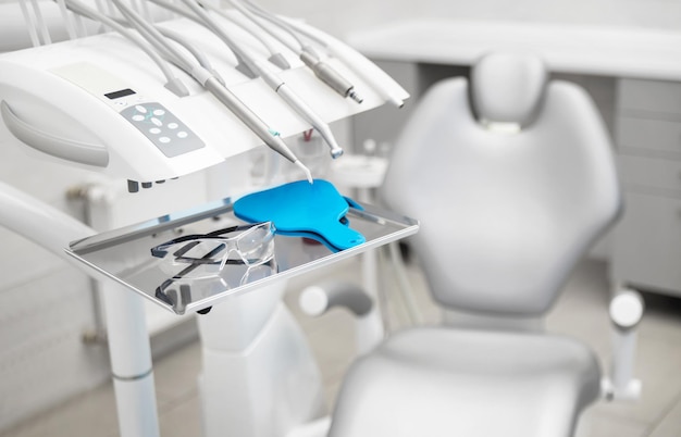 Workplace of a dentist in a clinic tools for dental surgery and\
protective glasses