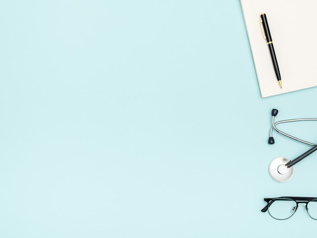 Photo workplace of doctor with notebook and stethoscope