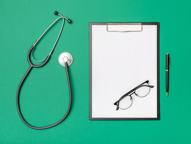 Workplace of a doctor with a notebook and stethoscope