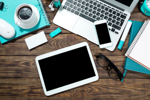 Workplace, laptop and tablet pc and phone on  table