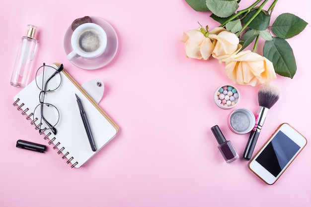 Workplace mockup with notebook, glasses, roses, phone and accessories