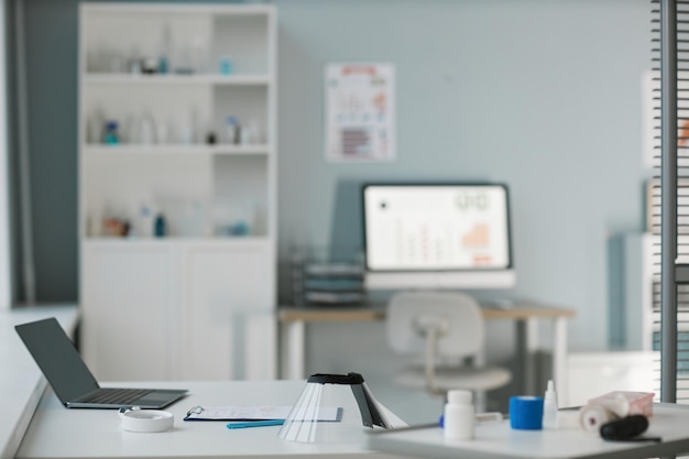 Workplace of modern veterinarian with laptop and medical equipment